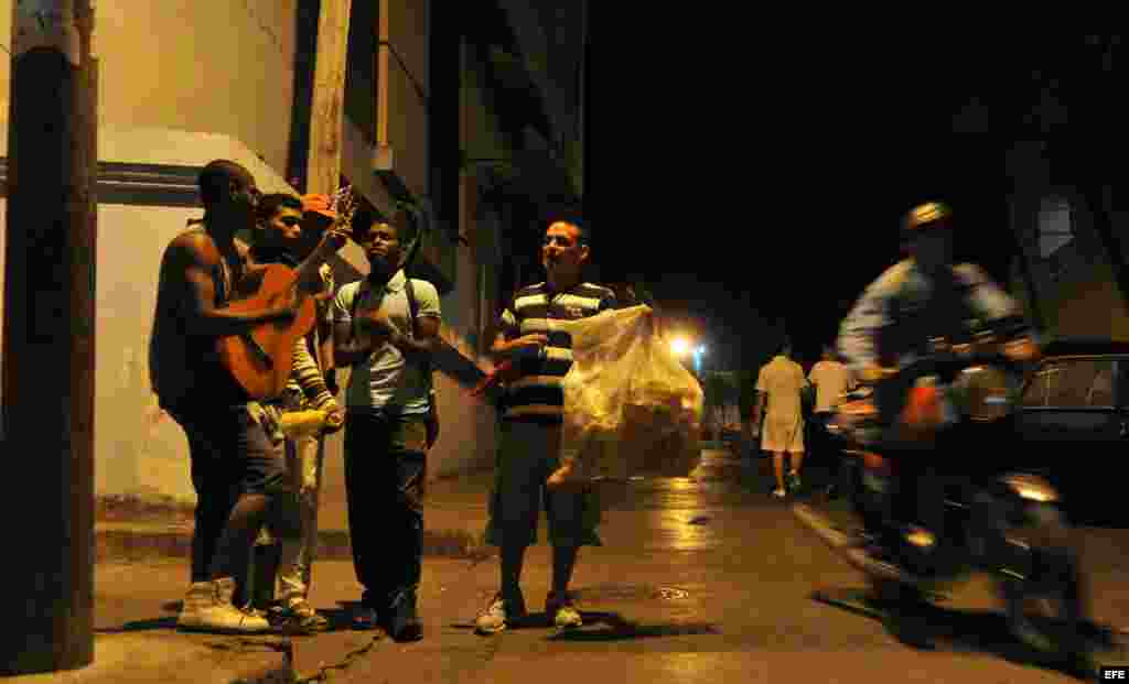 Un grupo de jovenes departe este martes en una calle del centro histórico de Santiago de Cuba (Cuba).