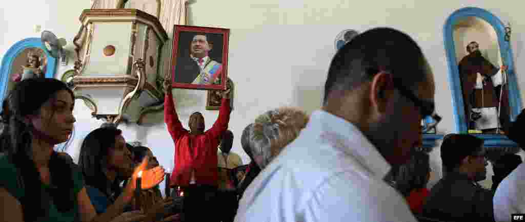 Funcionarios de la embajada de Venezuela en Cuba asisten el martes 8 de enero de 2013, a una misa por la salud del presidente venezolano Hugo Chávez en el santuario de la Virgen de Regla en La Habana (Cuba).